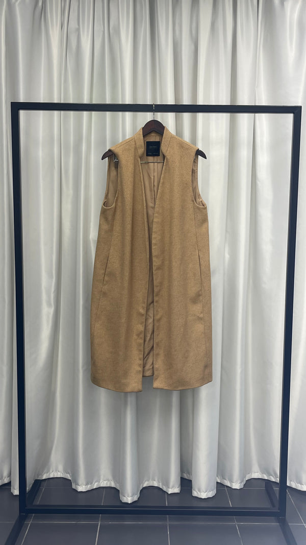 Beige hip length vest.